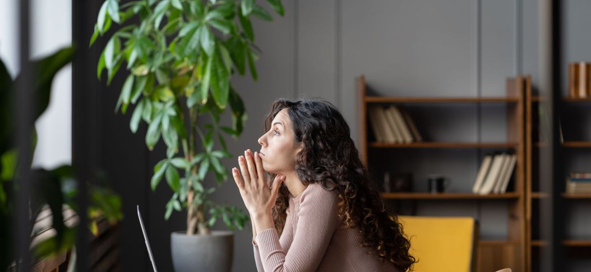Bored displeased businesswoman worker sit at desk with laptop tired thinking about problem solution